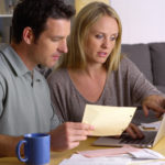 Couple reviewing home prices and housing market reports